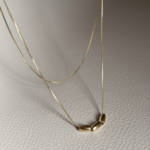 Gold double-layer necklace with three metal beads