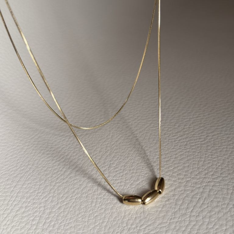 Gold double-layer necklace with three metal beads